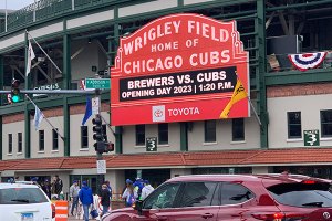 traffic passes down Clark Street with Wrigley Field marquee in background